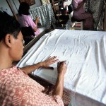 Artist drawing a Batik motif in pencil