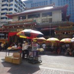 Vendors with flowers and fruits sale their goods to be used as offerings to Buddah